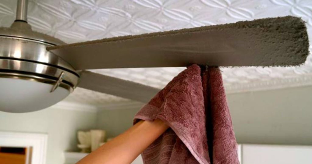 hand-cleaning-dust-from-a-ceiling-fan